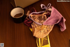 A pair of yellow lingerie sitting on top of a wooden table.