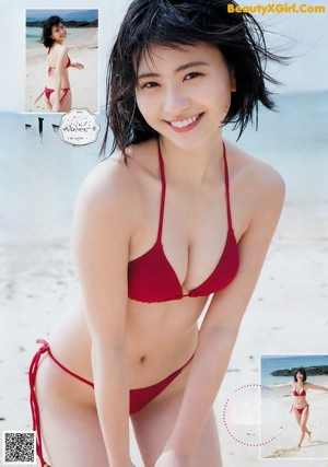 A woman in a blue bathing suit sitting on the edge of a pool.