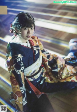 A woman in a kimono is posing for a picture.