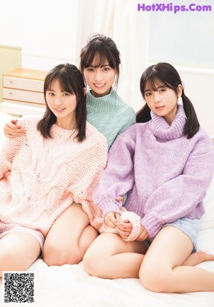 A group of young women sitting at a table eating food.