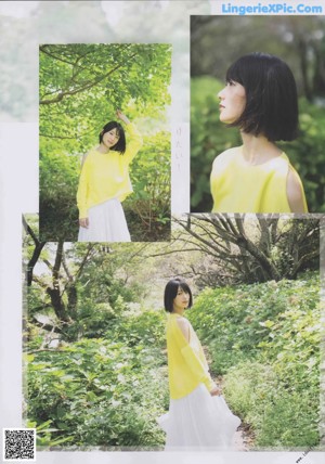 A woman in a yellow sweater and white skirt posing for a magazine.