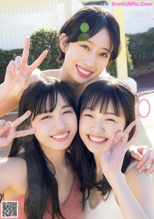 A group of three young women in bikinis posing for a magazine cover.