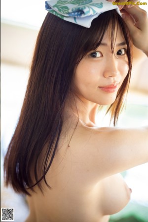 A naked woman in a white dress posing for a picture.