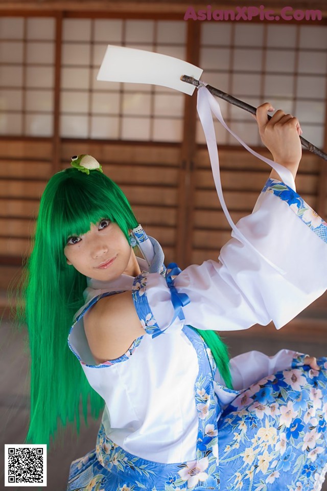 A woman with green hair holding a sword in her hand.