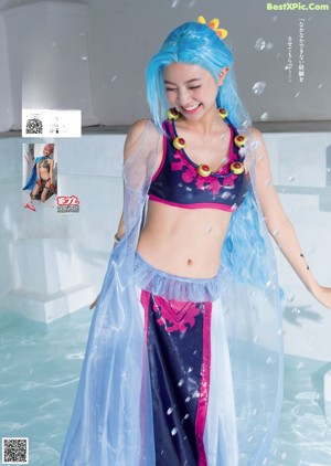 A woman in a bikini holding a sword and a blue cape.