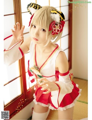 A woman in a red and white outfit posing for a picture.