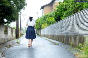 A woman standing in front of a wooden door.