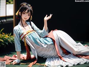 A woman in a pink kimono sitting on the floor.