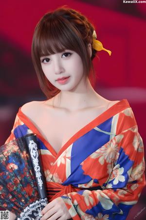 A naked asian woman leaning against a brick wall.