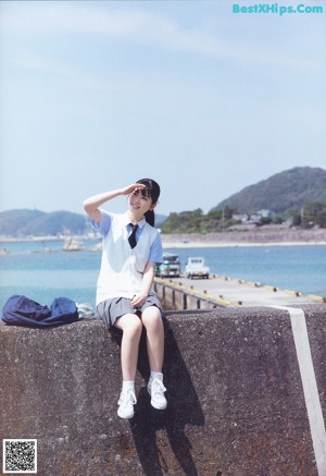 A young woman leaning against a green door.