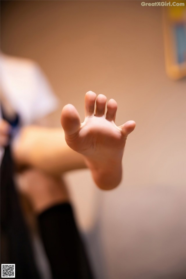 A close up of a person's foot with a blurry background.