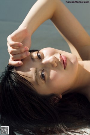 A woman in a blue bra posing for a picture.