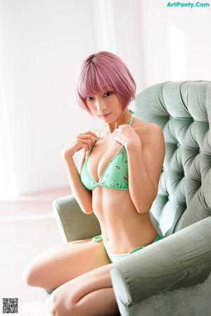 A woman in a blue and black lingerie posing for a picture.