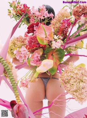 A close up of a woman's back with a bunch of flowers on it.